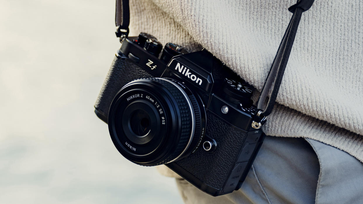  Nikon Zf with Z 40mm F2 lens attached on a strap by photographer's waist. 