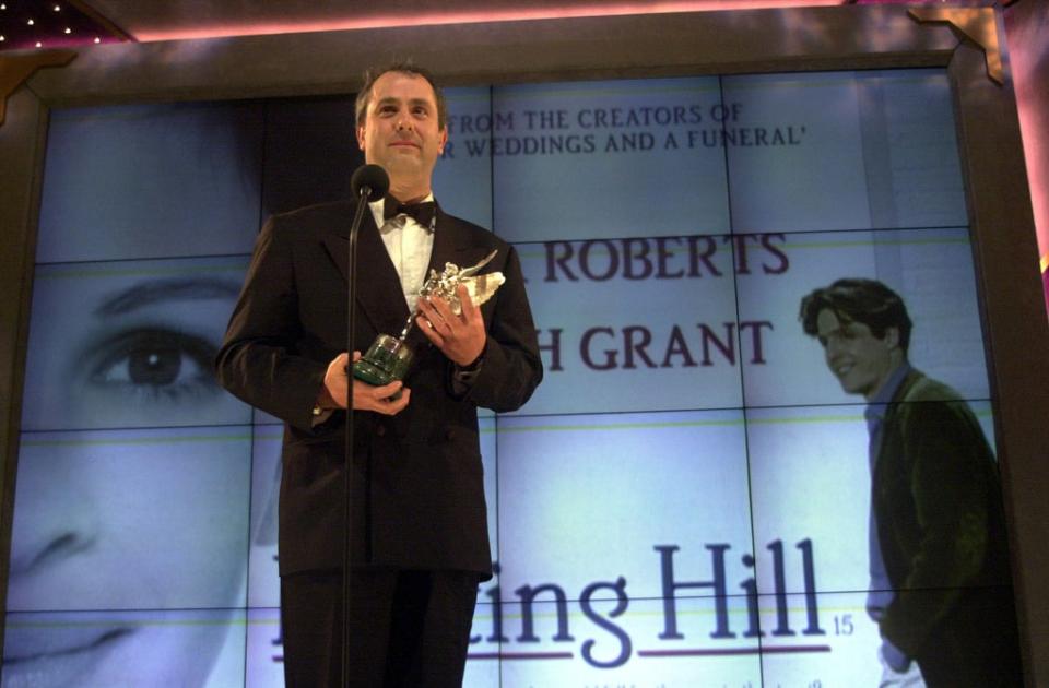 Roger Michell collecting an award for Notting Hill (PA Archive)