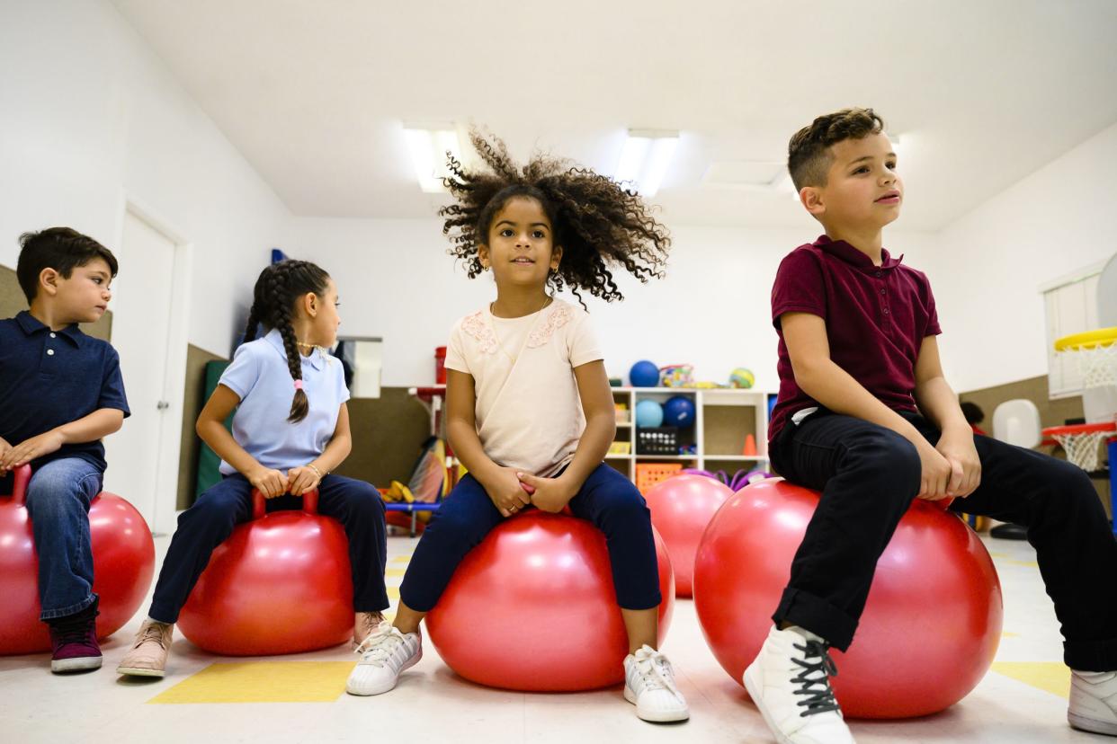 elementary students on exercise balls