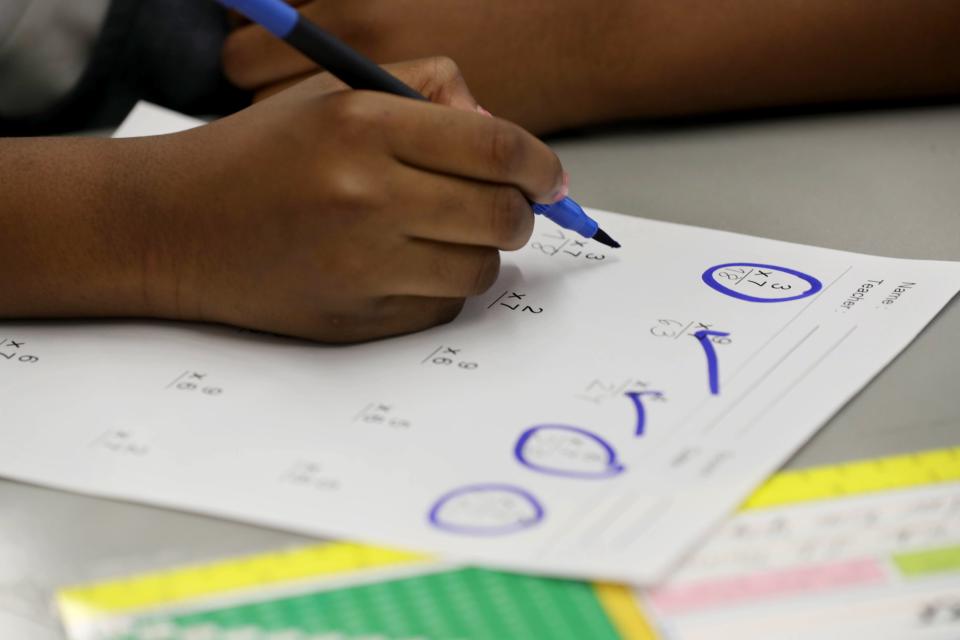 Amanda Oliver, a fourth-grade student at Leadership Prep Canarsie, a charter school in Brooklyn, N.Y., works on a math problem during the ninety minute math component of the school day Oct. 28, 2021. 