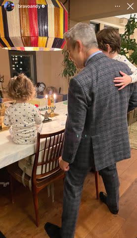 <p>Andy Cohen/Instagram</p> Lucy, Andy, and Ben Cohen celebrate the first night of Hanukkah 2023