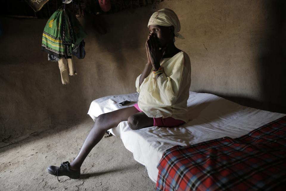 Winnie Keben becomes emotional as she speaks to a reporter in Meisori village in Baringo County, Kenya, on July 21, 2022. She explains how she lost her leg in a crocodile attack. That accident plus the loss of her home to rising water drove her and her family from their village. (AP Photo/Brian Inganga)