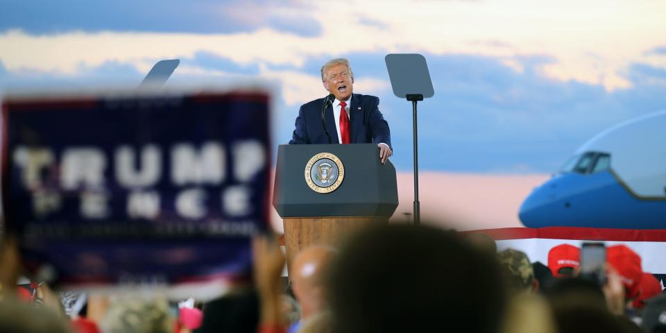 Trump speaks from a podium at his campaign rally in Manchester, New Hampshire.