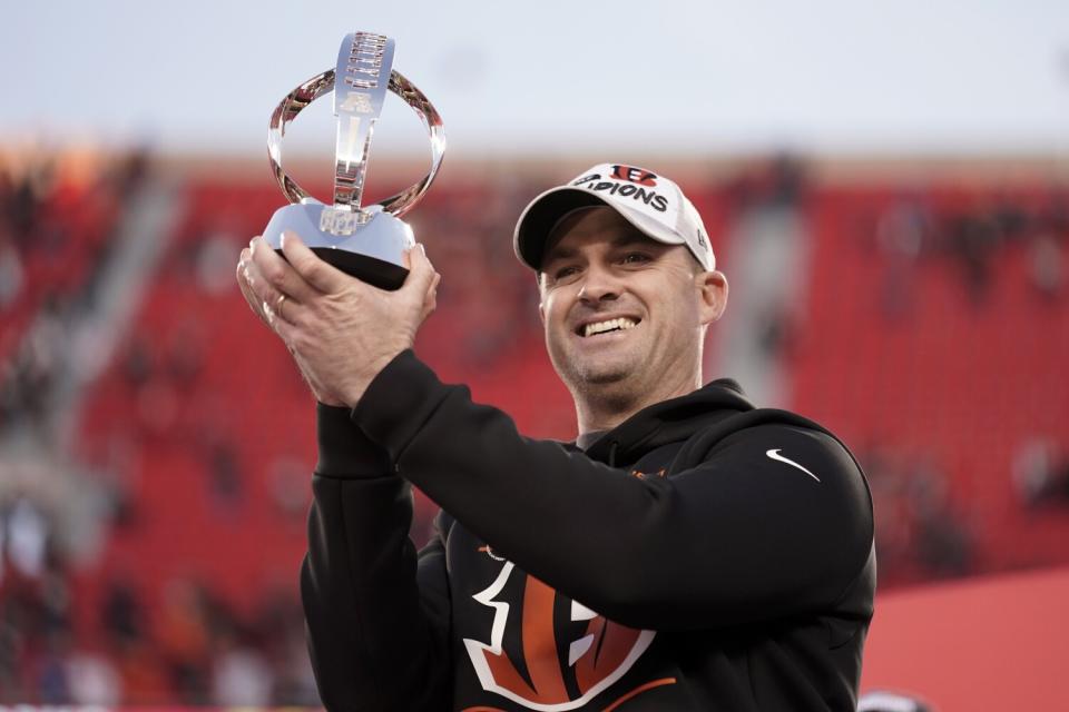 Bengals coach Zac Taylor holds the Lamar Hunt Trophy.