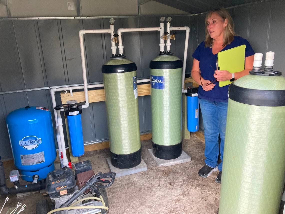 Kim Weatherford stands in her well house near filters that were installed to protect her family’s well water from PFAS chemical pollution. The toxic pollutants were discovered in the Darlington County well at levels of concern. The U.S. Environmental Protection Agency is investigating whether the pollution came from a South Carolina textile mill’s sludge, which was used as fertilizer at a nearby farm.