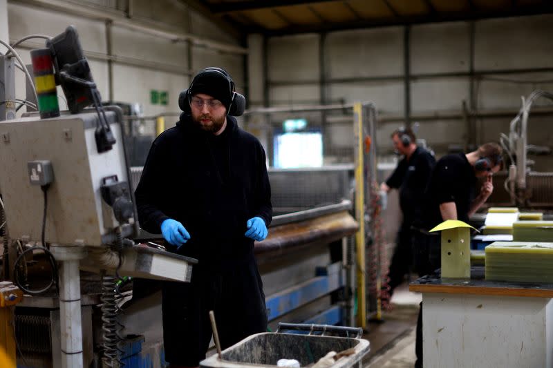 Men work in the Farrat factory in Altrincham