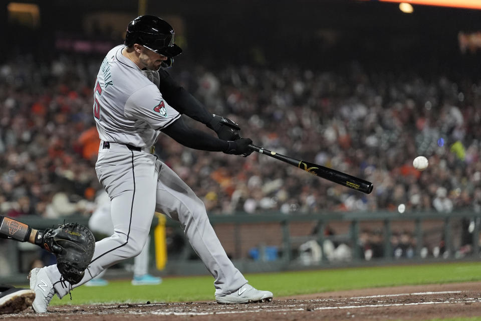 Arizona Diamondbacks' Randal Grichuk hits a two-run double against the San Francisco Giants during the fifth inning of a baseball game in San Francisco, Friday, April 19, 2024. (AP Photo/Jeff Chiu)