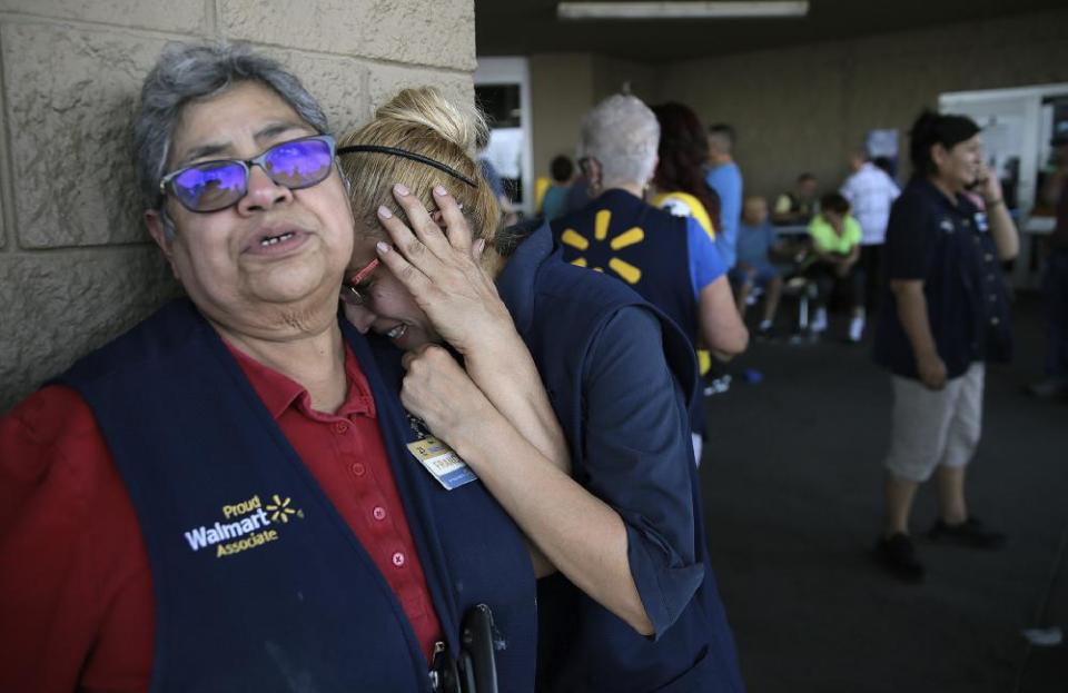 Employees stand outside the El Paso Walmart in August where a shooter killed 22 people.