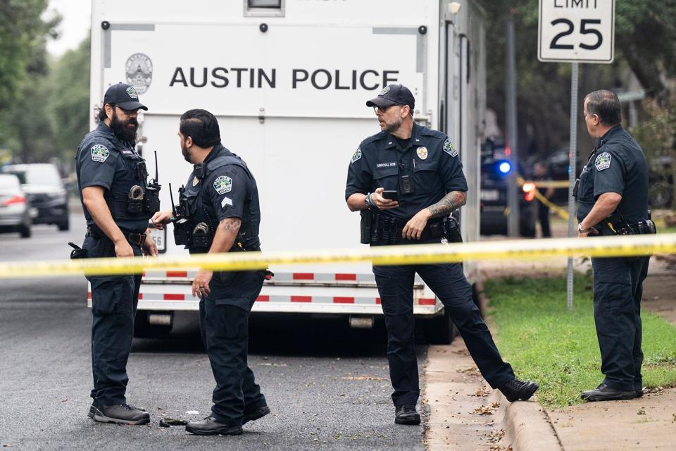 Police officers investigate the scene of Saturday morning's fatal shooting in the 9300 block of Bernoulli Drive. An Austin police officer was fatally shot, another officer was wounded, three other people, including the suspect, died, and another person was injured.