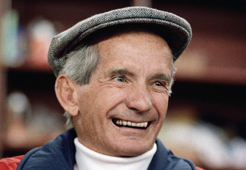 FILE - Bill Shoemaker enjoys a game of 'Race Horse Rummy' at Santa Anita Race Track in Arcadia, Calif., Feb. 2, 1990. (AP Photo)