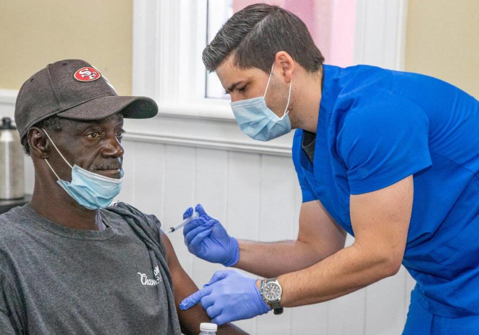 Medical assistant Mauricio Garcia injects Richard Anthony Sanders, a resident at Chapman Partnership, with the Moderna COVID-19 vaccine. Vaccinations were administered to residents, staff and families at the homeless shelter on Thursday, April 22, 2021.
