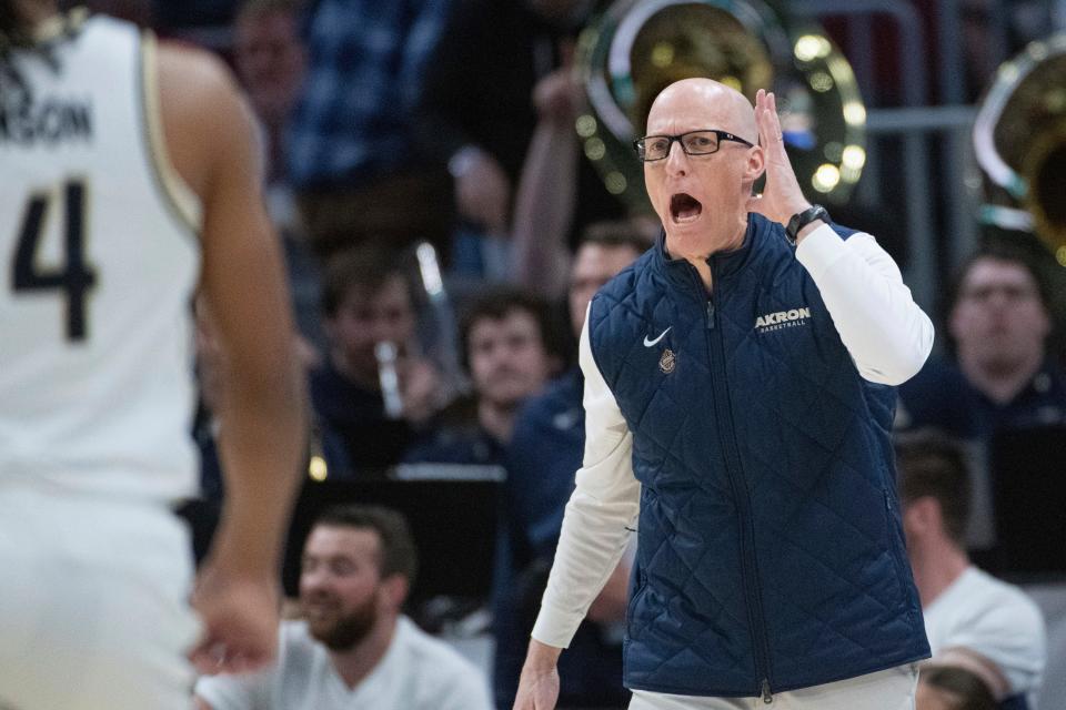 Akron head coach John Groce yells instructions to his team against Kent State during the first half of the Mid-American Conference Tournament championship game, Saturday, March 16, 2024, in Cleveland.