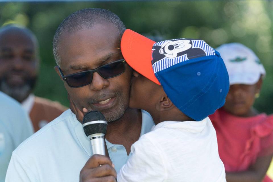 Boxing champion Arthur Johnson’s speech is interrupted by a kiss from his son during a groundbreaking ceremony in East St. Louis on Aug. 19, 2023. The Arthur Johnson foundation seeks to empower youth by providing them with the discipline, comradely and mentorship offered by the sport of boxing.