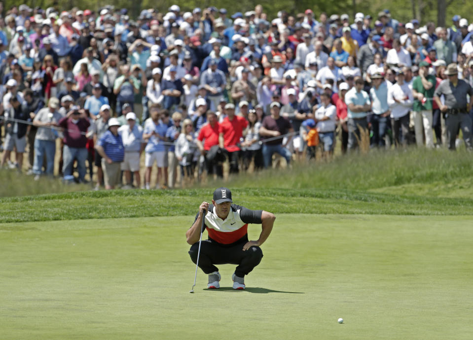 Brooks Koepka lines up a putt on the fifth green during the first round of the PGA Championship golf tournament, Thursday, May 16, 2019, at Bethpage Black in Farmingdale, N.Y. (AP Photo/Julio Cortez)