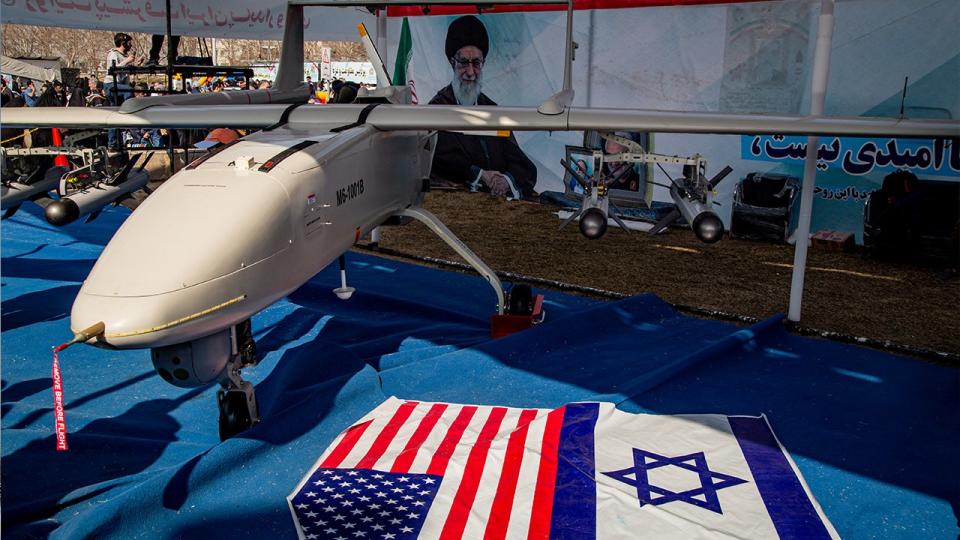 Missiles and UAVs are shown with Israeli and American flags on the ground for the people on the side of the road in Tehran, Iran, on February 11, 2024. (Photo by Hossein Beris / Middle East Images / Middle East Images via AFP)