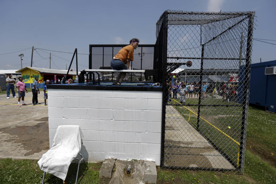 An inmate sits in a water dunk game at the Angola Prison Rodeo in Angola, La., Saturday, April 26, 2014. Louisiana’s most violent criminals, many serving life sentences for murder, are the stars of the Angola Prison Rodeo, the nation’s longest-running prison rodeo that this year celebrates 50 years. The event has grown from a small “fun” event for prisoners into big business, with proceeds going into the Louisiana State Penitentiary Inmate Welfare Fund for inmate education and recreational supplies. (AP Photo/Gerald Herbert)