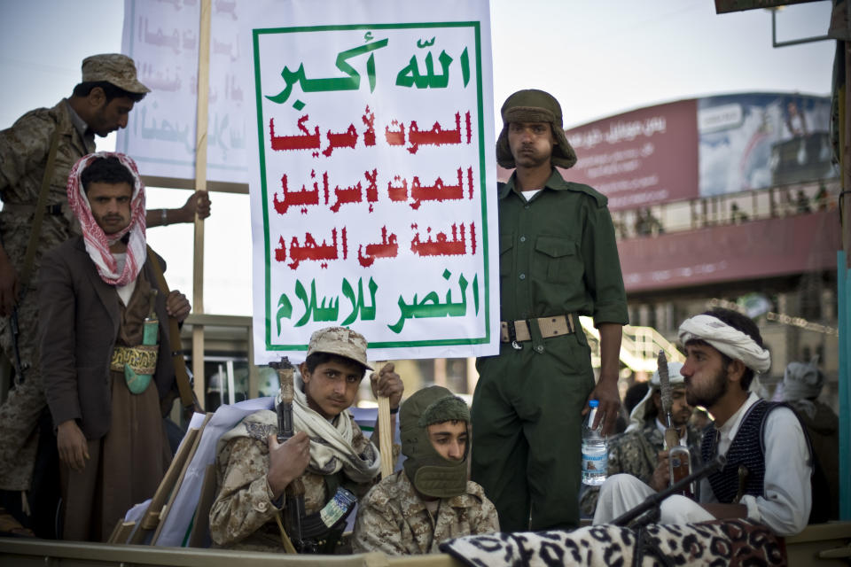 CLICK IMAGE for slideshow: Houthi Shiite fighters wearing an army uniform ride on a pickup truck as they guard a street during a demonstration to show support for their comrades in Sanaa, Yemen, Friday, Jan. 23, 2015. Thousands of protesters demonstrated Friday across Yemen, some supporting the Shiite rebels who seized the capital and others demanding the country&#39;s south secede after the nation&#39;s president and Cabinet resigned. Arabic on the posters reads, &quot;God is great. Death to America. Death to Israel. A curse on the Jews. Victory to Islam.&quot; (AP Photo/Hani Mohammed)