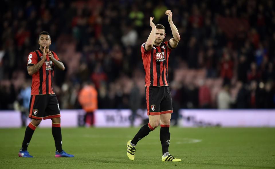 <p>Bournemouth’s Joshua King and Simon Francis applaud fans after the game </p>