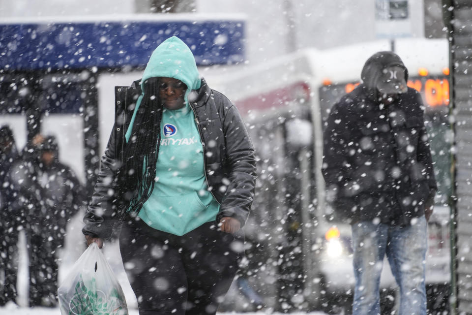 People walk during a winter snow storm in Philadelphia, Tuesday, Feb. 13, 2024. Parts of the Northeast were hit Tuesday by a snowstorm that canceled flights and schools and prompted warnings for people to stay off the roads, while some areas that anticipated heavy snow were getting less than that as the weather pattern changed. (AP Photo/Matt Rourke)
