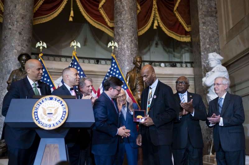 Speaker of the House Mike Johnson, R-La., awards a Congressional Gold Medal to Larry Doby Jr., son of Major League Baseball player and civil rights activist Larry Doby, who was the first African American to play in the American league. Photo by Bonnie Cash/UPI