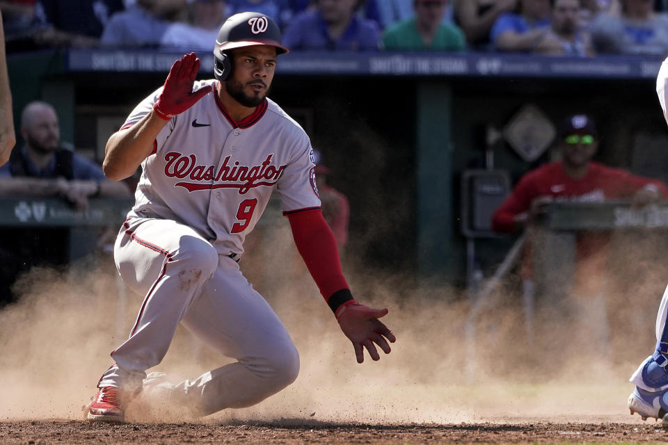 Washington Nationals' Jeimer Candelario celebrates after scoring on a double hit by Corey Dickerson during the sixth inning of a baseball game against the Kansas City Royals Saturday, May 27, 2023, in Kansas City, Mo. (AP Photo/Charlie Riedel)