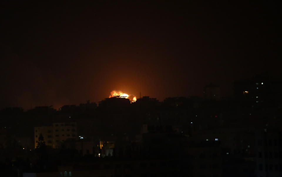 An explosion caused by Israeli airstrikes is seen on Gaza City, early Friday, March 15, 2019. Israeli warplanes attacked militant targets in the southern Gaza Strip early Friday in response to a rare rocket attack on the Israeli city of Tel Aviv, as the sides appeared to be hurtling toward a new round of violence. (AP Photo/Adel Hana)