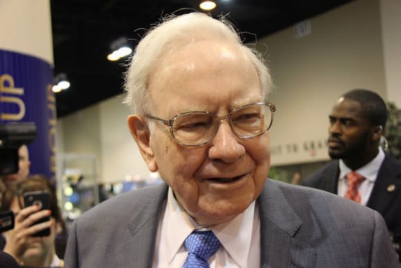 Warren Buffett speaking to a group of people at a convention.