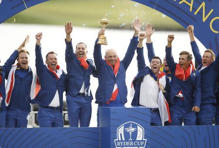 Golf - 2018 Ryder Cup at Le Golf National - Guyancourt, France - September 30, 2018. Team Europe captain Thomas Bjorn lifts the trophy as Tyrrell Hatton, Paul Casey, Sergio Garcia, Rory McIlroy, Alex Noren, Thorbjorn Olesen and Ian Poulter celebrate after winning the Ryder Cup REUTERS/Carl Recine