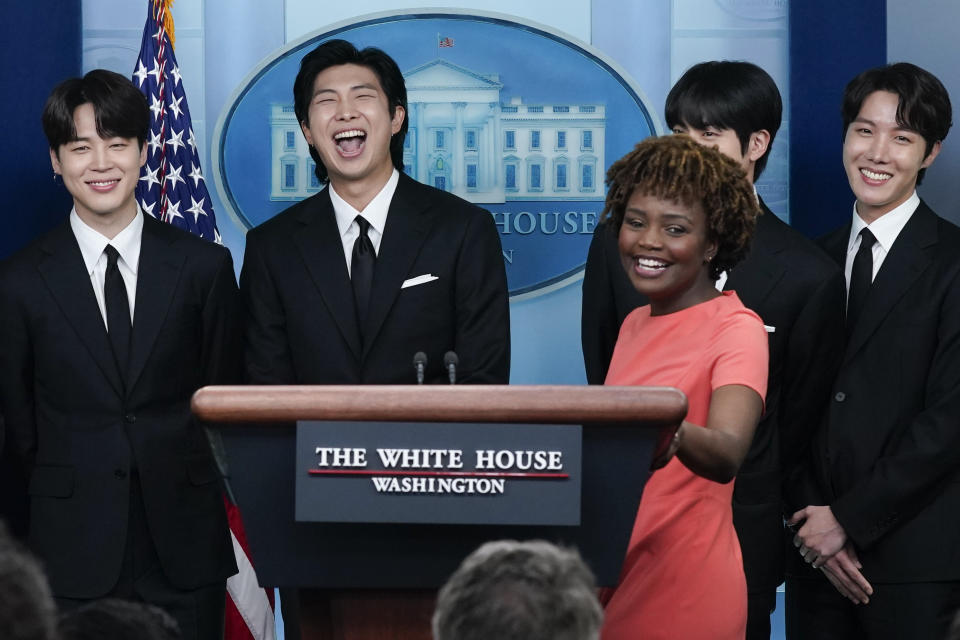 Members of the K-pop supergroup BTS from left, Jimin, RM, Jin, and J-Hope, join White House press secretary Karine Jean-Pierre during the daily briefing at the White House, Tuesday, May 31, 2022, in Washington. (AP Photo/Evan Vucci)