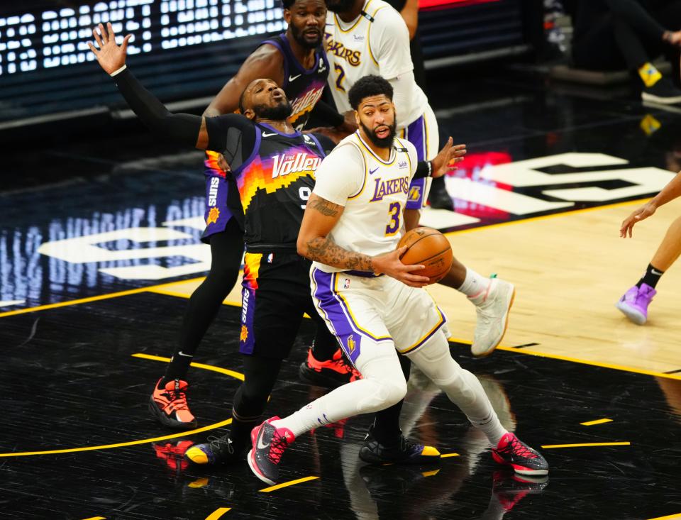 Los Angeles Lakers forward Anthony Davis controls the ball against Phoenix Suns forward Jae Crowder in the second half of Game 1.