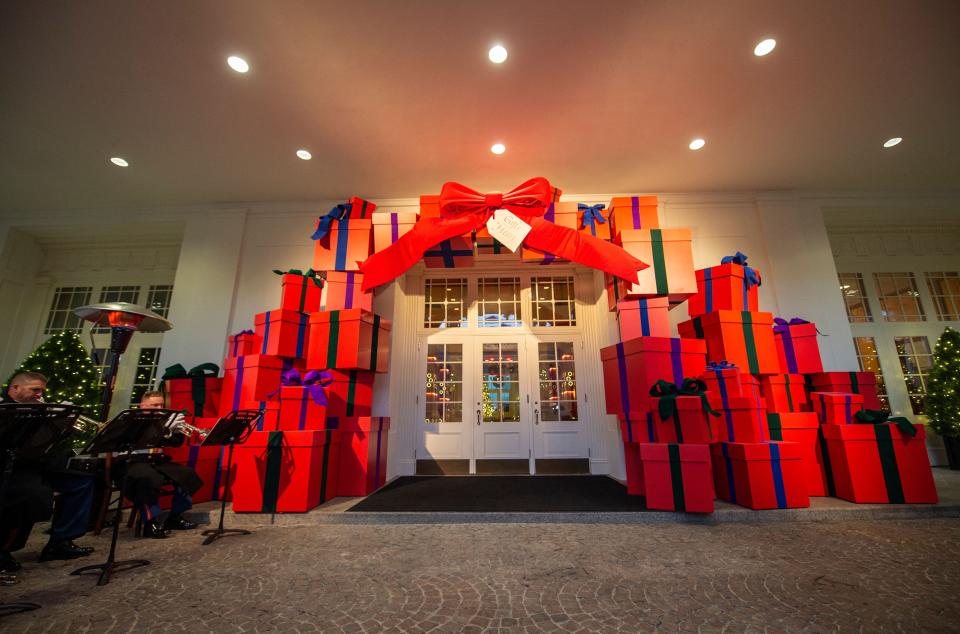 An archway of red presents at the East Wing entrance, part of the 2021 White House Christmas decorations