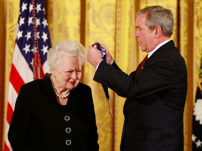 FILE PHOTO: U.S. President Bush presents veteran actress Olivia de Havilland with a National Medal of Arts in Washington