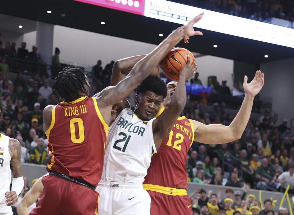 Baylor center Yves Missi (21) is pressured by Iowa State forward Tre King, left, and forward Robert Jones, right, in the first half of an NCAA college basketball game, Saturday, Feb. 3, 2024, in Waco, Texas. (AP Photo/Rod Aydelotte)