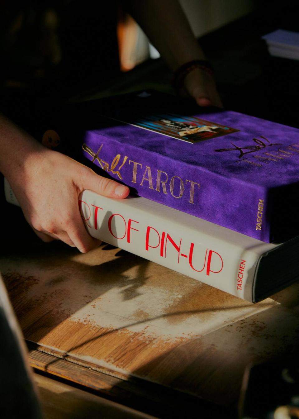 Hands holding two art books