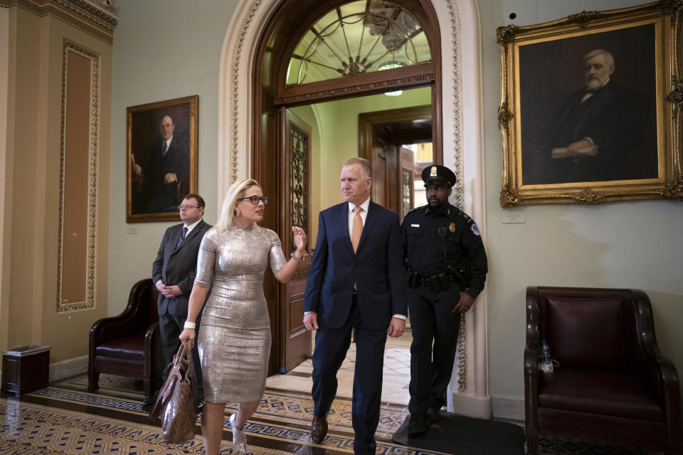 Sens. Kyrsten Sinema and Thom Tillis leave the Senate chamber on Feb. 25, 2020. / Credit: J. Scott Applewhite / AP