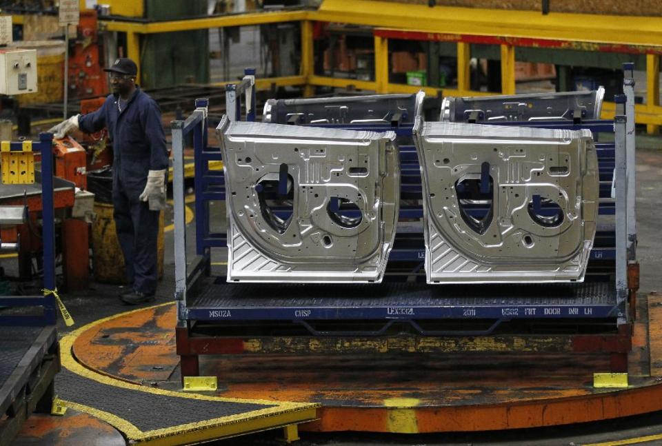 In this April 4, 2012, photo, an auto worker at the Ford Stamping Plant in Chicago Heights, Ill. Plummeting sales in Europe, and no hope for a quick fix in the troubled region, hurt Ford's second-quarter profit and forced the company to lower its full-year earnings forecast Wednesday, July 25, 2012. (AP Photo/Charles Rex Arbogast)