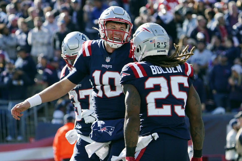 New England Patriots running back Brandon Bolden (25) celebrates with quarterback Mac Jones (10) after his touchdown during the first half of an NFL football game against the New York Jets, Sunday, Oct. 24, 2021, in Foxborough, Mass. (AP Photo/Mary Schwalm)