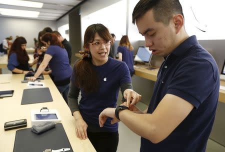 An Apple customer is assisted in setting up his Apple Watch, which he had purchased online, at the company's flagship store in Sydney April 24, 2015. REUTERS/Jason Reed