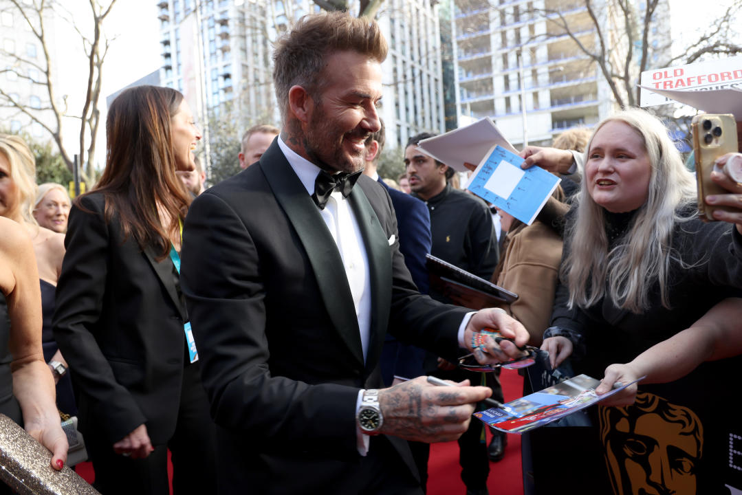 LONDON, ENGLAND - FEBRUARY 18: David Beckham signs autographs for fans as he attends the EE BAFTA Film Awards 2024 at The Royal Festival Hall on February 18, 2024 in London, England. (Photo by Tristan Fewings/BAFTA/Getty Images for BAFTA)