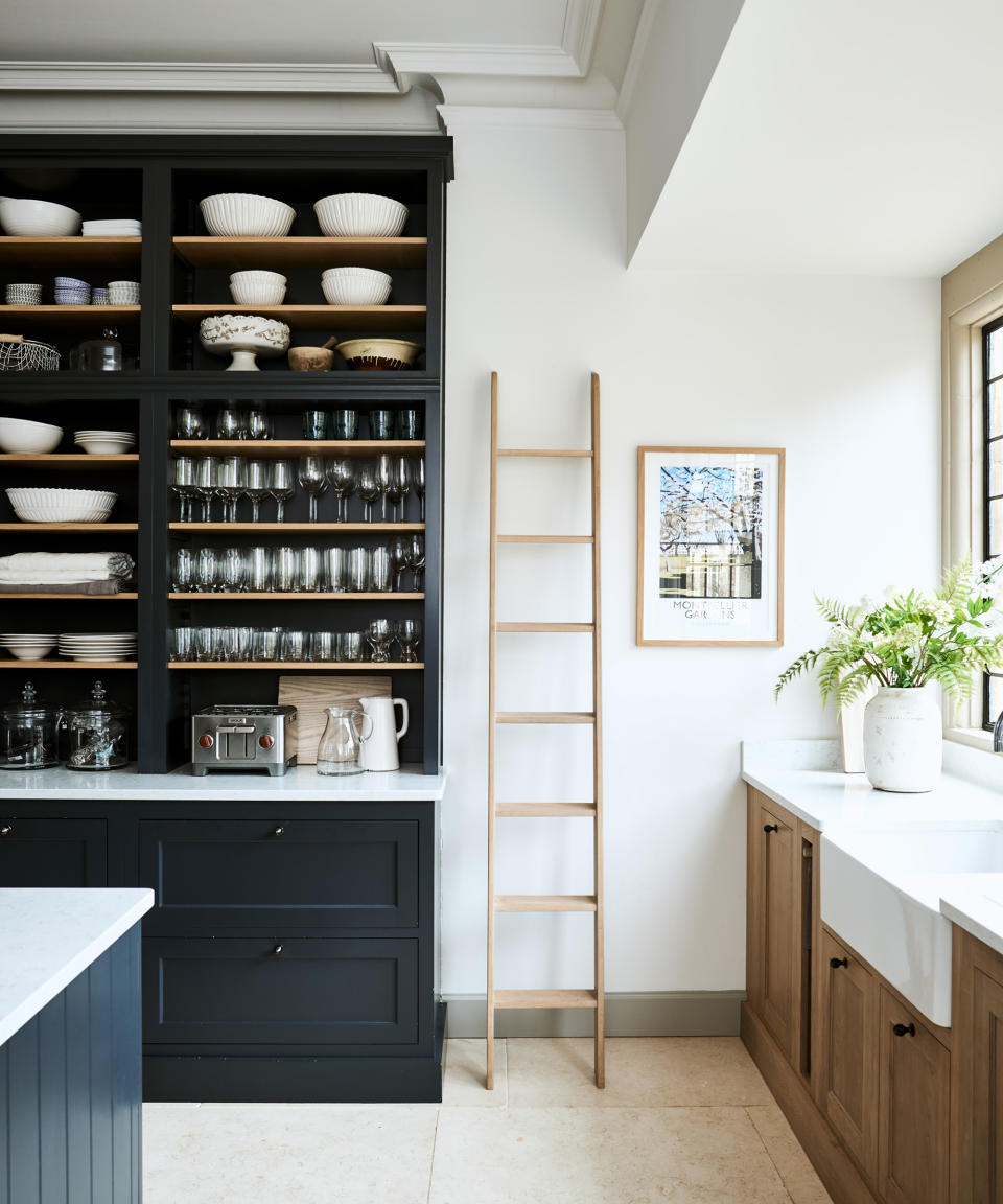<p> Mixed materials or finishes create a kitchen that's full of character, but what has really caught our eye in this room is the clever use of vertical space on a wall that demands narrow cabinetry.  </p> <p> It's a perfect kitchen idea for a galley layout – solid fronted units would have made the space feel narrower, but open shelving has the opposite effect, adding depth and – because you can usefully store your best pieces on it – a ton of character. </p>