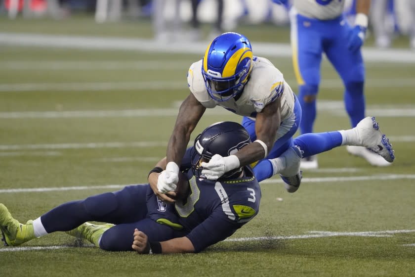 Seattle Seahawks quarterback Russell Wilson (3) slides to a stop on a carry as Los Angeles Rams.