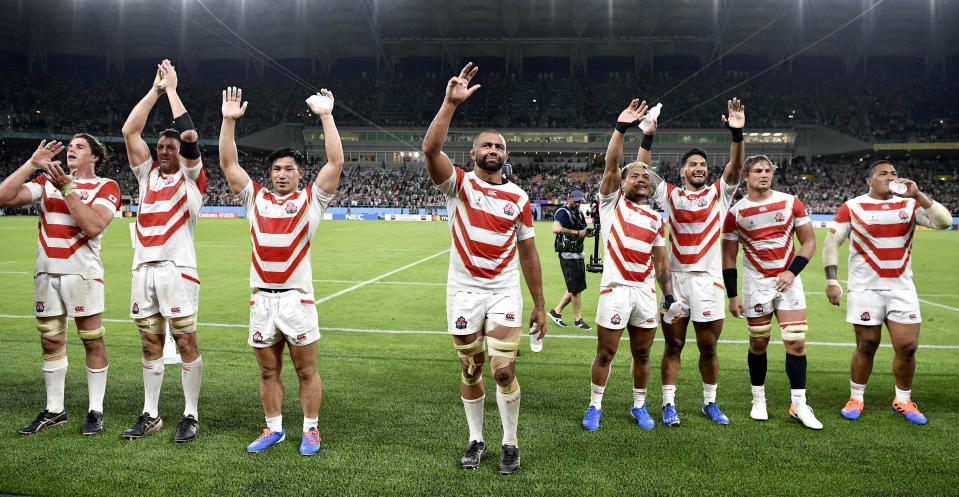 Japan's players wave to supporters after winning over Ireland during the Rugby World Cup Pool A game at Shizuoka Stadium Ecopa between Japan and Ireland in Shizuoka, Japan, Saturday, Sept. 28, 2019. (Kyodo News via AP)