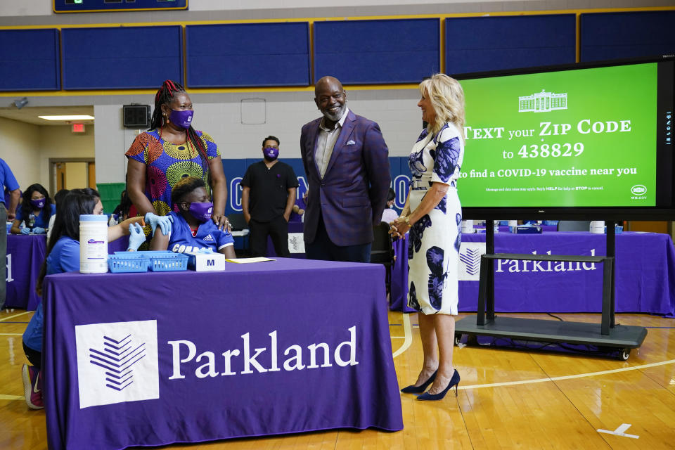 First lady Jill Biden and former Dallas Cowboy and Football Hall of Famer Emmitt Smith tour a vaccination site at Emmett J. Conrad High School in Dallas, Tuesday, June 29, 2021. (AP Photo/Carolyn Kaster, Pool)