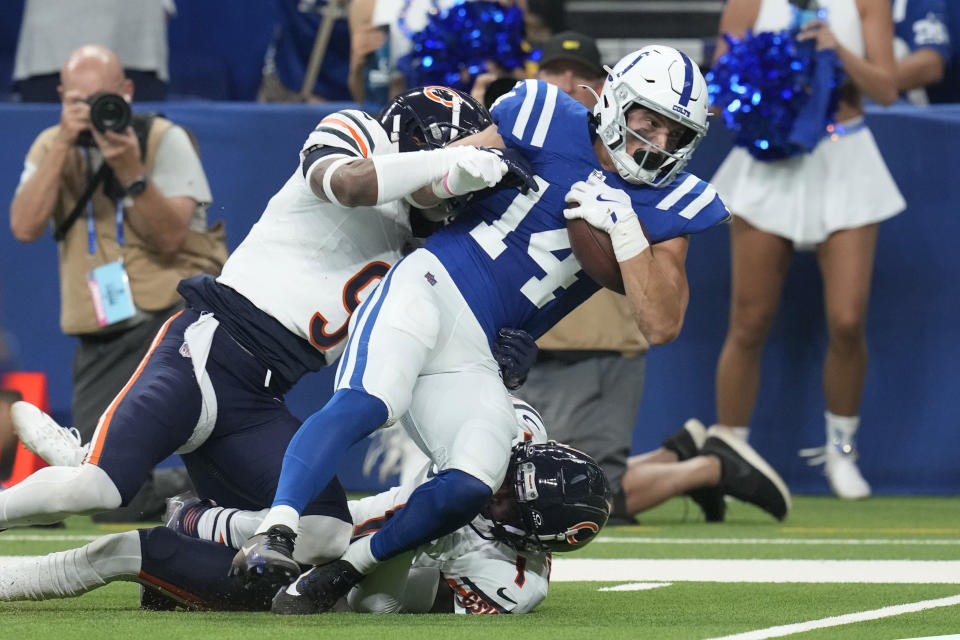 Indianapolis Colts wide receiver Alec Pierce (14) is stopped by Chicago Bears safety Jaquan Brisker (9) after making a catch during the first half of an NFL football game Sunday, Sept. 22, 2024, in Indianapolis. (AP Photo/Darron Cummings)