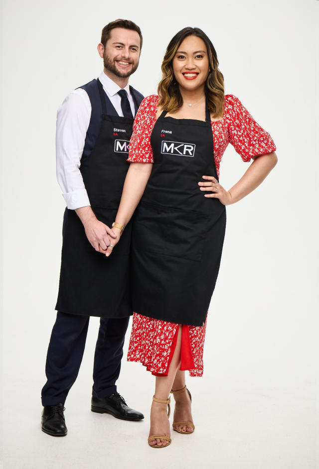 MKR 2022 contestants Steven and Frena stand smiling in MKR aprons
