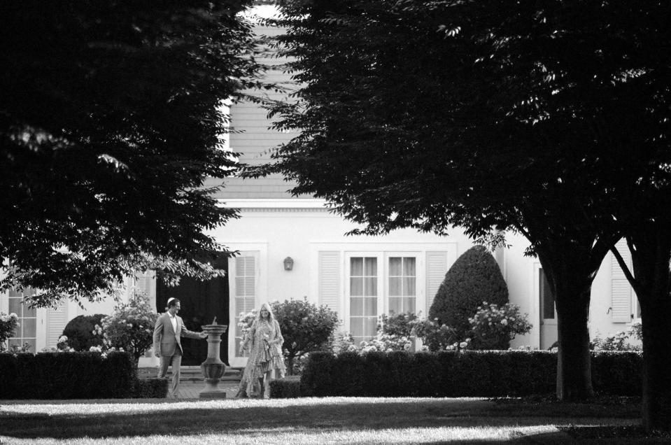 Just before I walked down the aisle, my beloved parents met me at the edge of the rose garden.