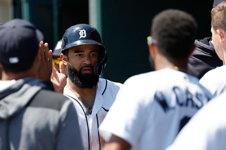 Tigers center fielder Derek Hill receives congratulations from teammates after scoring in the second inning May 15, 2022 against the Orioles at Comerica Park.