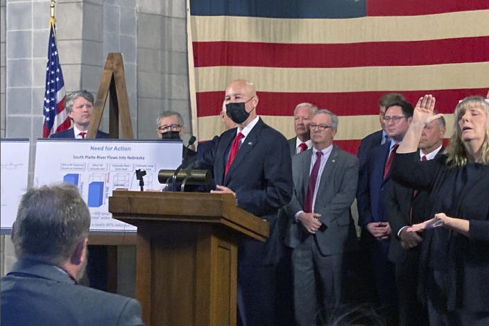 Nebraska Gov. Pete Ricketts announces a $500 million plan to build canals in neighboring Colorado on Monday, Jan. 10, 2022, in Lincoln, Neb. The project would divert water out of Colorado to ensure that it gets its share under the South Platte Compact, a water-sharing agreement enacted in 1923. (AP Photo/Grant Schulte)