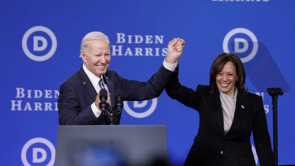 President Joe Biden (left) and Vice President Kamala Harris (right) hold hands onstage after speaking at the Democratic National Committee winter meeting in February in Philadelphia. (Photo: Anna Moneymaker/Getty Images)