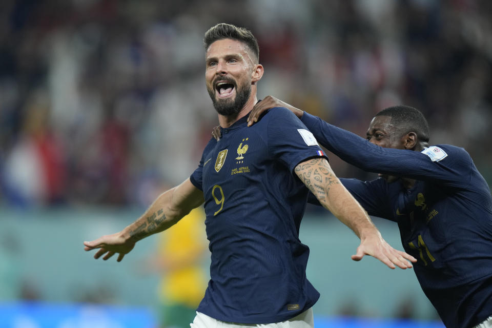 France's Olivier Giroud, left, celebrates with his teammate Ousmane Dembele after scoring his side's second goal during the World Cup group D soccer match between France and Australia, at the Al Janoub Stadium in Al Wakrah, Qatar, Tuesday, Nov. 22, 2022. (AP Photo/Francisco Seco)